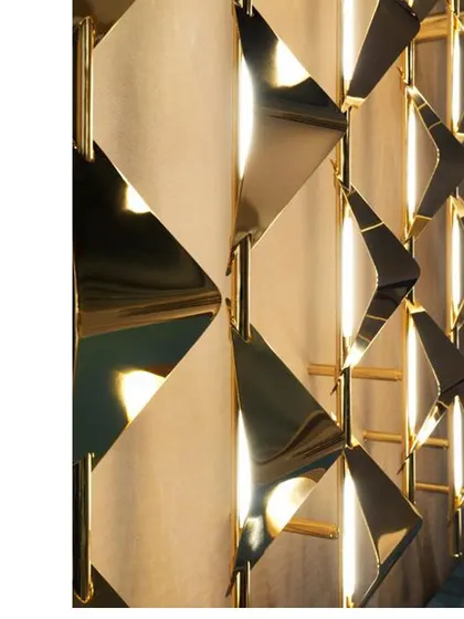 A close-up of our custom-made geometric wall light. The three-dimensional metal shapes create a beautiful play of light and shadow, turning a simple wall into a feature.