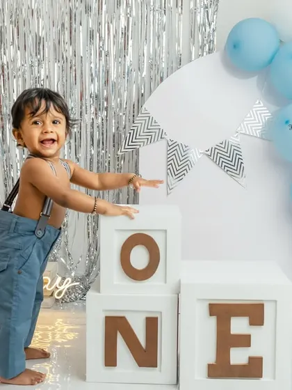 Almost ready to take his first steps into year two. This shot captures the excitement and energy of a one-year-old, perfectly framed by the festive birthday decorations.