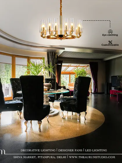 In this dramatic dining room, a customizable gold and crystal chandelier serves as an eye-catching centerpiece. Its design elevates the high-contrast decor, turning every meal into a luxurious event.