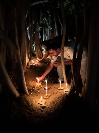 A participant lighting a candle during our Vesak celebration. These small, mindful actions connect us to a larger spiritual tradition and community.