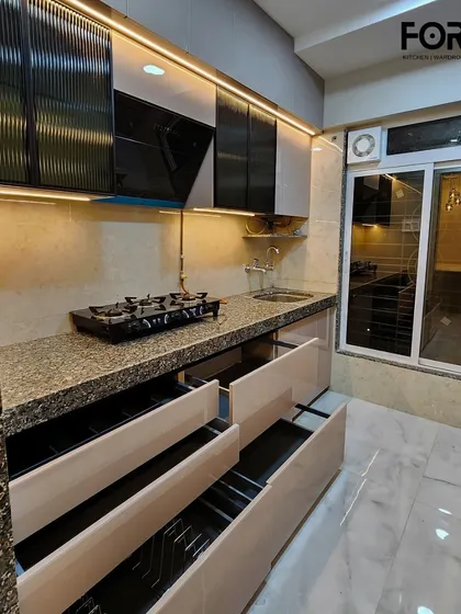 A view of the deep drawers in this modular kitchen. The organized compartments within make it easy to store and find everything you need, from small spice jars to larger cooking utensils.