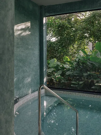 A private jacuzzi area within the Aqua Spa, where a large window frames the lush greenery outside. This is a perfect example of our biophilic design approach, bringing the calming presence of nature indoors.