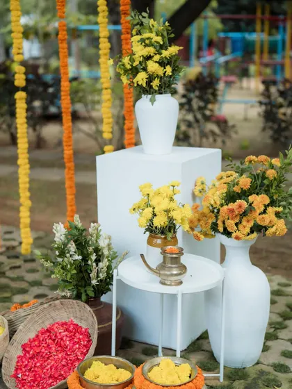 A modern and clean decor setup with vases of yellow chrysanthemums, perfect for a minimalist Haldi or Mehendi.