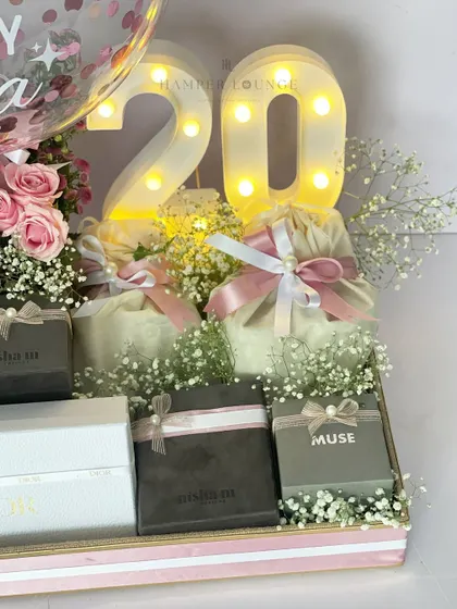 Another angle of the 20th birthday hamper, focusing on the glowing "20" marquee lights surrounded by flowers and beautifully packaged gifts, creating a truly festive and celebratory atmosphere.
