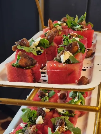 A tiered display of our refreshing watermelon, feta, and caramelized fig salad bites. This appetizer is a perfect balance of sweet, savory, and fresh flavors.