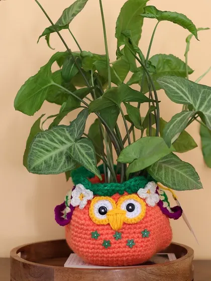 A closer look at the autumn Owlie basket, showing the little embroidered details and floral embellishments.