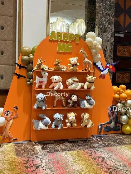 Another angle of the popular 'Adopt Me' station, surrounded by character cutouts of Timon and Scar.