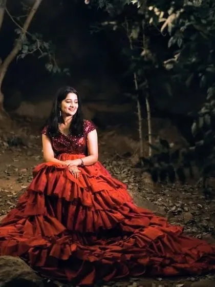 Our client looks like she's stepped out of a dream in this red ruffle trail gown. The dress is perfect for creating dramatic and romantic photos.