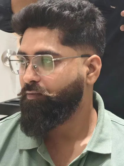 This client is looking sharp with his new fade haircut and perfectly shaped beard.