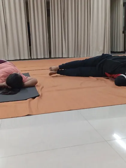 Participants in a prone resting posture, an important part of the Angamardana practice for recovery and awareness.