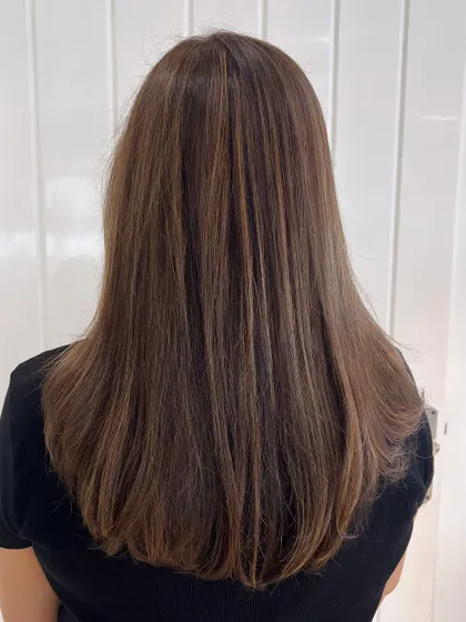 Another angle of our subtle and natural-looking highlights. The straight styling really shows off the precision of the color placement.