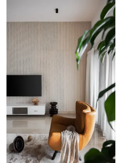 The living space uses a palette of light wood, crisp whites, and a pop of tan for a cozy yet bright atmosphere. The fluted wall adds subtle texture.