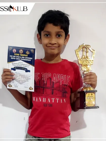Student Sai Kamal Raj holds his trophy after securing third place at the Sri Sadguru Chessmartz & Music Academy tournament in Hubballi.