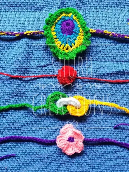 A set of four distinct rakhi designs, including a beautiful peacock feather motif and simple floral patterns.