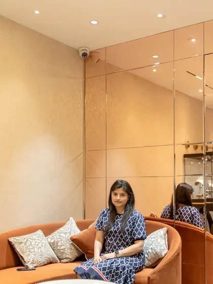 Here I am in the completed jewelry boutique. My goal was to create an inviting space where textures blend harmoniously, and the rose-gold tinted mirror wall adds warmth and visually expands the room.
