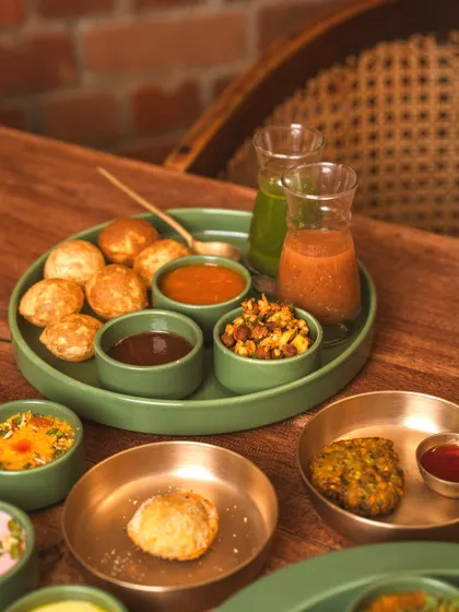 A modern take on pani puri, presented as a deconstructed platter. This shot showcases the innovative approach of the restaurant, perfect for attracting adventurous foodies.