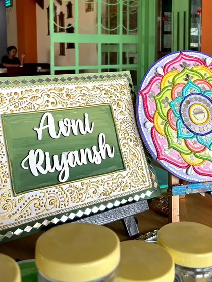 A finished Lippan art nameplate and a colorful mandala mirror, two of the beautiful items created in my workshops.