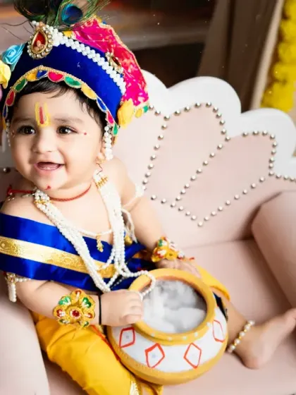 A close-up shot of our little Krishna, capturing his bright smile and the intricate details of his costume and jewelry.