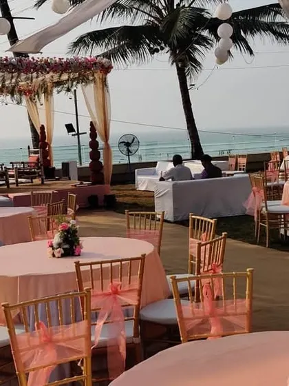 This photo captures the full scope of a pastel pink beach wedding setup. You can see the mandap, guest seating with round tables, and the beautiful ocean view that we incorporated into the design.