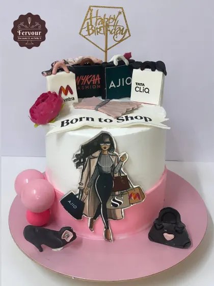 A "Born to Shop" cake for a fashion lover. The design features edible shopping bags from popular Indian brands like Myntra, Ajio, and Nykaa.