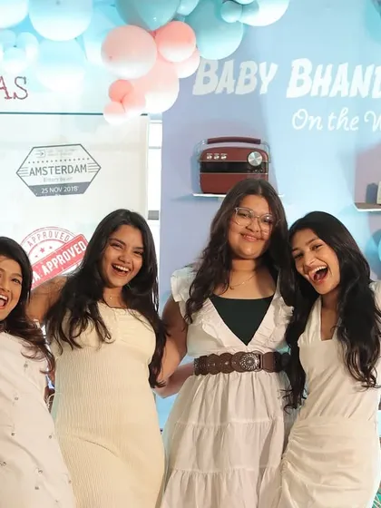 Happy guests enjoying the fun, interactive photo booth at the travel-themed shower.