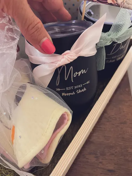 A gift for the new parents is a thoughtful touch. I included these personalized "Mom" and "Dad" tumblers in the half-birthday hamper to celebrate their journey too.