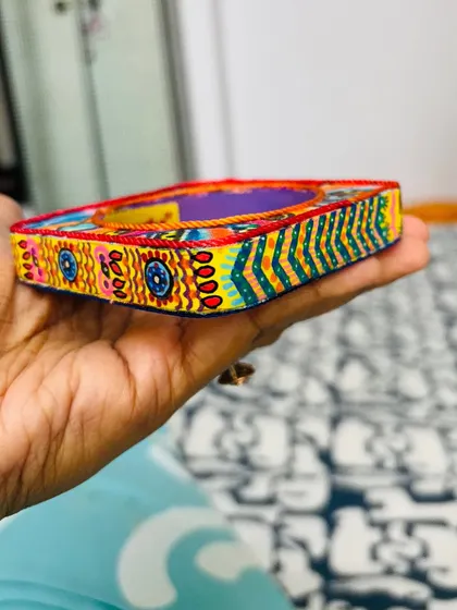 The details are what make each piece special. This close-up shows the fine threadwork and hand-painted patterns that define the Banjara Bangle.