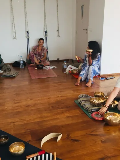 Students practicing with singing bowls during our training in Casablanca. The beautiful studio at RoofYoga provides the perfect atmosphere for learning.