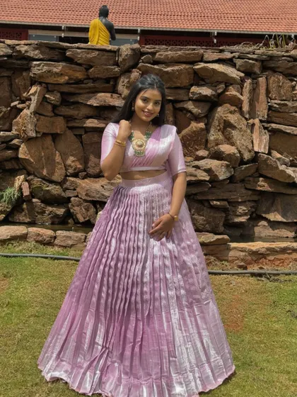 A client wearing a beautiful lavender Langa Dhawani with a pleated metallic skirt, perfect for a modern ethnic look.