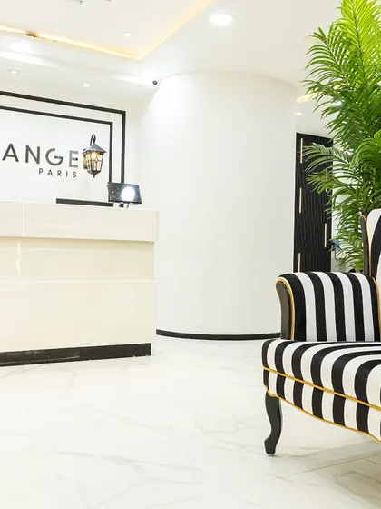 The elegant reception at our Kemps Corner salon. The chic black and white decor, accented with a statement armchair, sets the tone for the pure French luxury that awaits you inside.