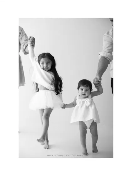 The bond between siblings is a story I love to tell. This timeless black and white family portrait captures that pure, unscripted connection as two sisters walk hand in hand, creating a memory of their shared childhood.
