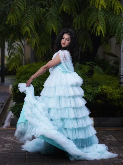 This shot captures the movement of the gown and the model's elegant pose. The makeup was designed to look beautiful from every angle, with a focus on glowing skin and softly defined features.