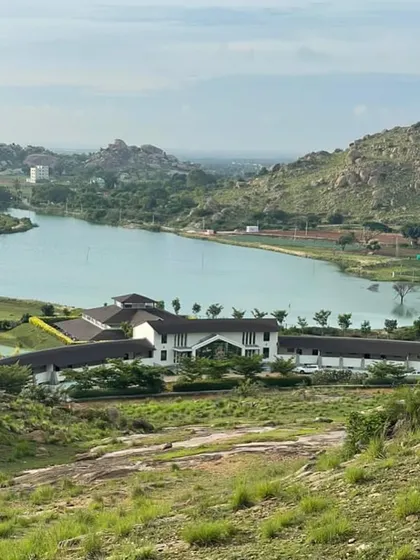 From the hillsides, you can see how our retreat rests peacefully by the water's edge. This perspective highlights the scale of the natural beauty that surrounds you during your stay, offering endless space for reflection.