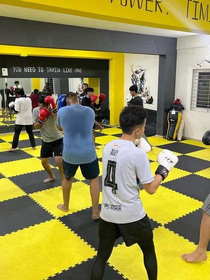 A full view of the gym during a busy boxing session. The energy is high as everyone works to get better.