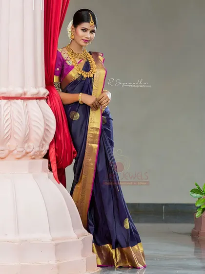 A full-length shot of the navy blue and magenta silk saree, a perfect bridal or wedding guest outfit.