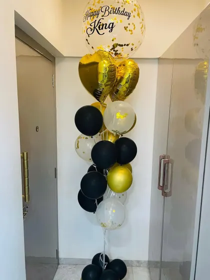 The perfect balloon bouquet for him. This arrangement for a 'King' uses a classic black and gold theme with foil hearts and a personalized confetti balloon for a royal celebration.