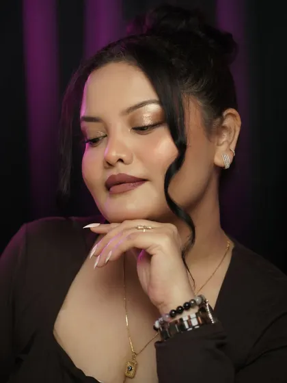 A soft glam look with a focus on luminous skin and a defined eye. The high bun and simple accessories keep the look modern and chic.