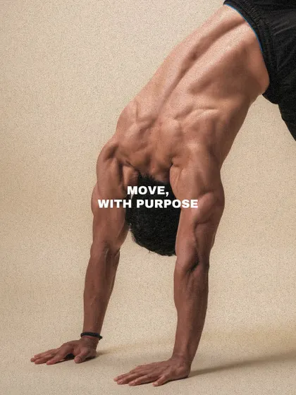 A client holds a downward dog position, a foundational yoga and movement pose that stretches the entire posterior chain. We believe in moving with purpose.