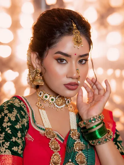 A close-up on the details of this elegant South Indian look. The focus is on the sharp eye makeup and the beautifully sculpted features, complemented by a bold, earthy lip color.