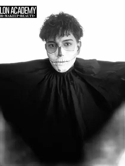 A striking black and white portrait of a student's skeleton makeup, emphasizing the shading and contouring techniques used to create a three-dimensional effect.