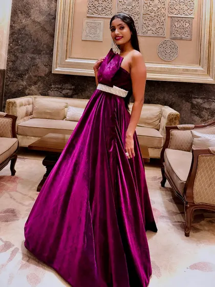 The one-shoulder detail of this magenta velvet gown adds a unique and fashionable twist. It's a perfect choice for making a stylish statement.