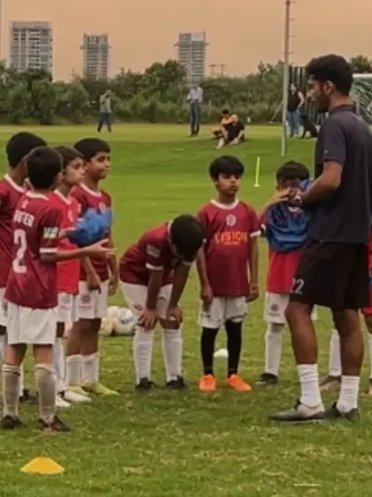 A coach speaks to his team during a break. These huddles are vital for motivation and tactical reinforcement.