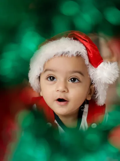 A creative shot through a Christmas wreath. We love finding unique perspectives to make your festive photos stand out.