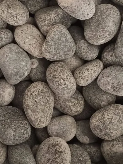 Unpolished grey river pebbles, a classic and versatile choice for any landscape project.
