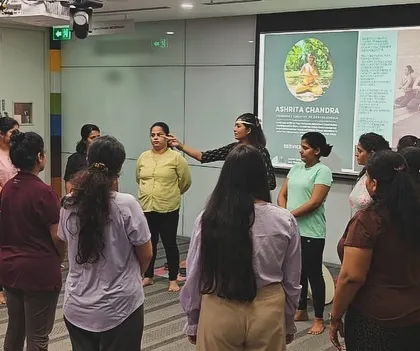 Wellness is also about connection. I encourage an interactive and supportive atmosphere, here engaging with employees at ABB during a gentle standing movement exercise.
