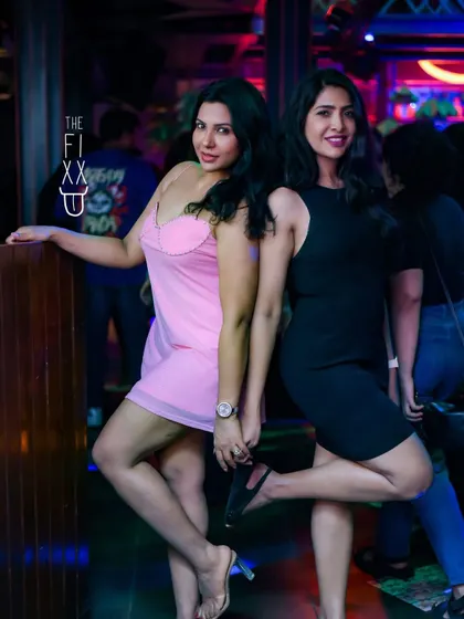 Two friends posing for a picture, making memories at The Fixx Bar. My goal is to create a backdrop of great music for nights like these.