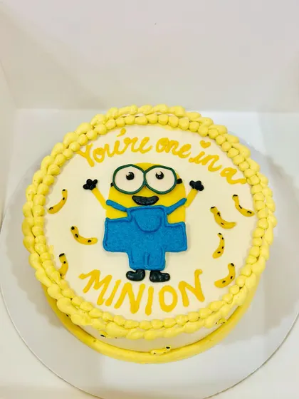 You're one in a minion. A fun and bright cake featuring a hand-piped Minion character, perfect for bringing a smile to anyone's face.