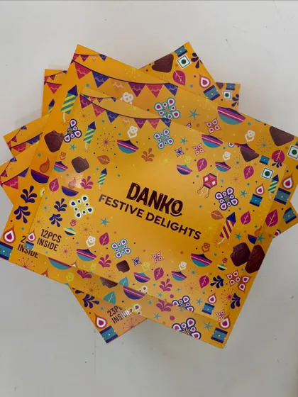 A stack of Danko's Festive Delight chocolate boxes, available in 12-piece and 23-piece options to suit different budgets and needs.