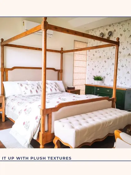 This bedroom features a classic four-poster bed, bringing a touch of timeless elegance. We paired it with a delicate floral wallpaper and a plush upholstered bench to create a cozy and opulent feel.