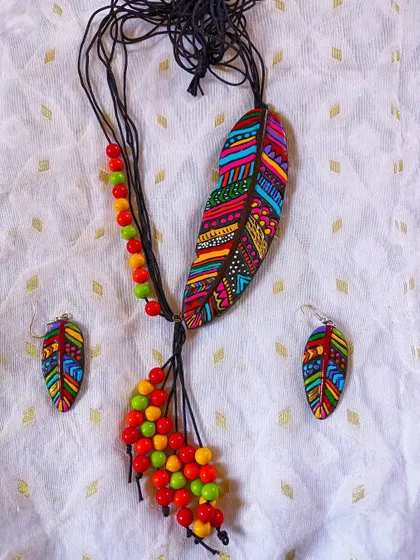 A stunning feather-pendant necklace with intricate multi-color painting. This is a true work of art and a standout piece in any collection.